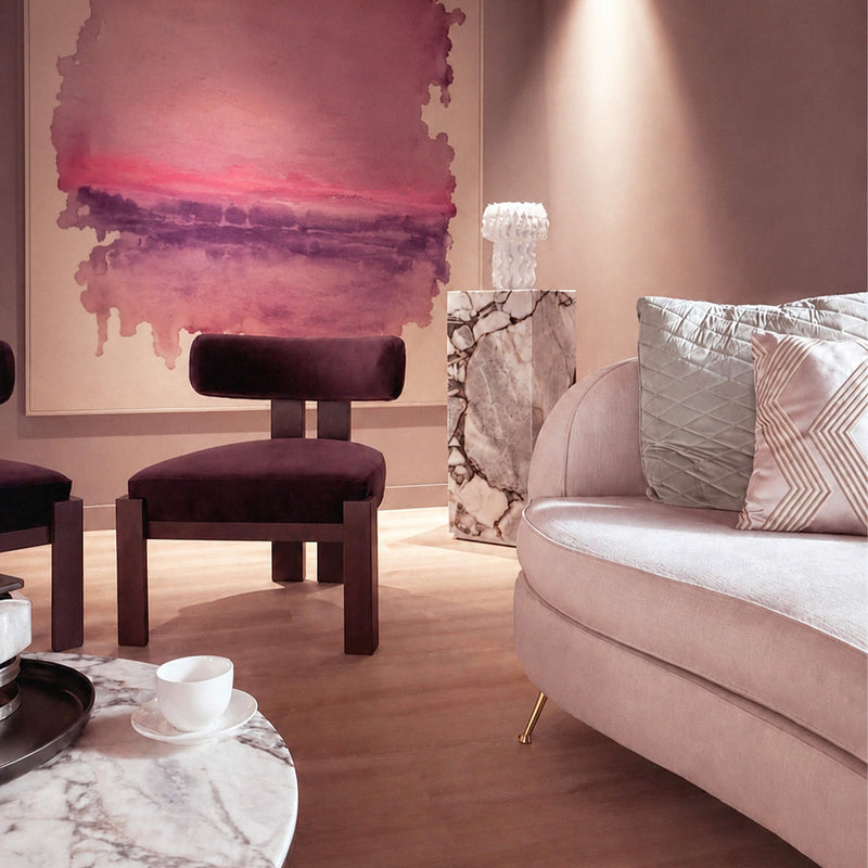 Modern Aesthetic Clinic with a soft rose sofa, purple chair, and abstract art by Dr Joseph Hkeik on the wall.