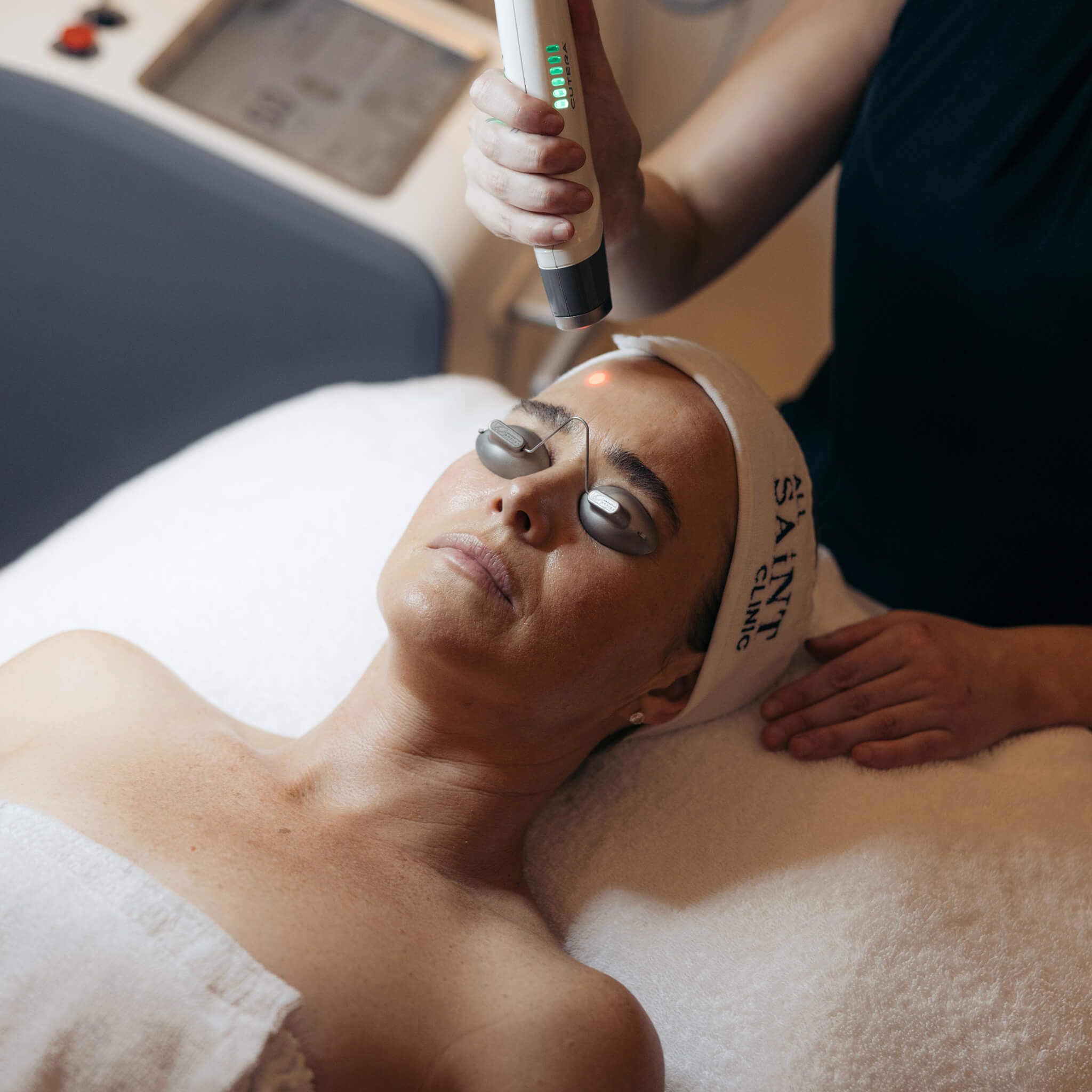 Woman receiving a Laser Genesis treatment, a gentle, non-invasive laser that warms the skin to support collagen production, improve tone and texture, and reduce redness.