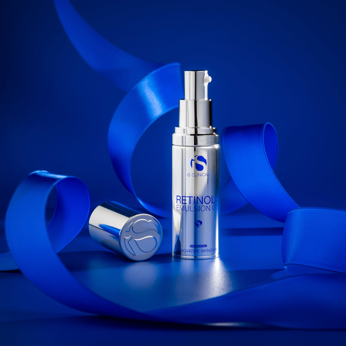 Advanced iS Clinical Retinol Emulsion skincare on a blue background with ribbons.