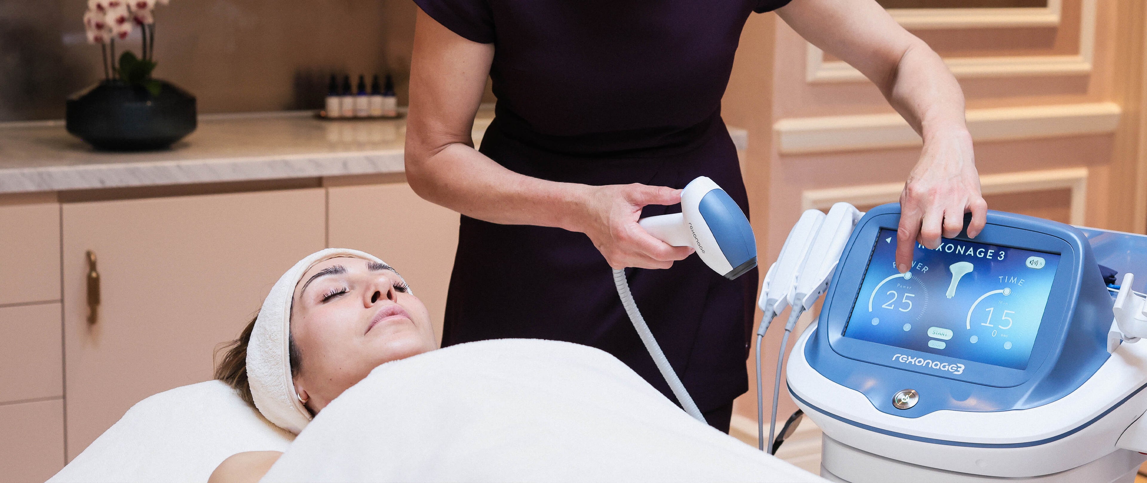Woman receiving a rexonage quantum lift treatment with a skincare device at Le Petit Saint Clinic in London Mayfair.