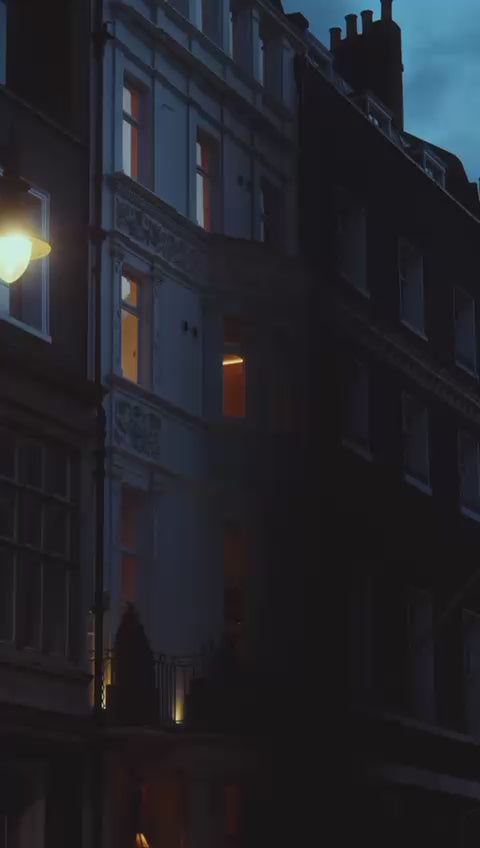 Le Petit Saint Mayfair at dusk, softly illuminated exterior with warm ambient lighting against the evening sky.